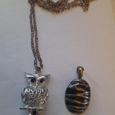 Sale Photo Thumbnail #1377: Owl pendant on silver tone chain and black and silver tone oval pendant