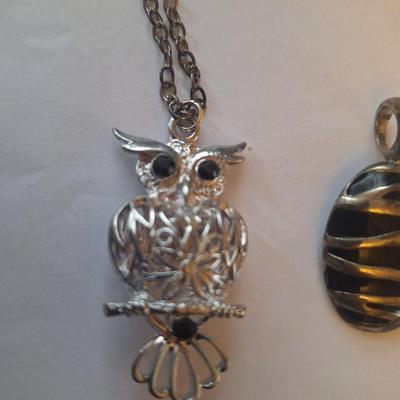 Sale Photo Thumbnail #1378: Owl pendant on silver tone chain and black and silver tone oval pendant