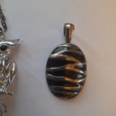 Sale Photo Thumbnail #1379: Owl pendant on silver tone chain and black and silver tone oval pendant