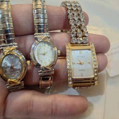 Sale Photo Thumbnail #1419: all need new batteries.  all are stretch bands.
the one with the rhinestones has a stone missing, see first photo above the watch 3 positions.