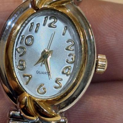Sale Photo Thumbnail #1422: all need new batteries.  all are stretch bands.
the one with the rhinestones has a stone missing, see first photo above the watch 3 positions.