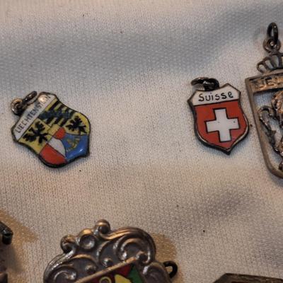Sale Photo Thumbnail #1485: charms from various destinations and possibly some free mason related.