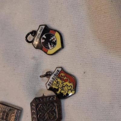Sale Photo Thumbnail #1482: charms from various destinations and possibly some free mason related.