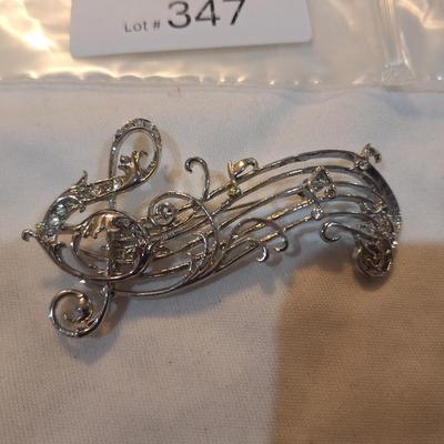 Sale Photo Thumbnail #1519: music staff brooch with treble clef and notes
