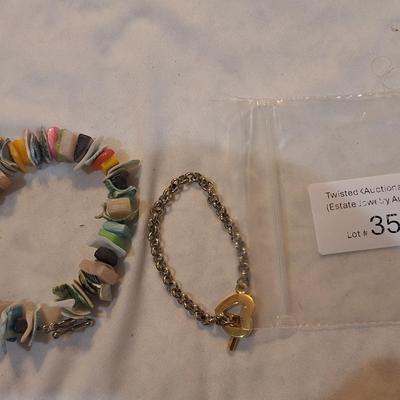 Sale Photo Thumbnail #1574: Multi color shell bracelet and a silver and gold tone bracelet