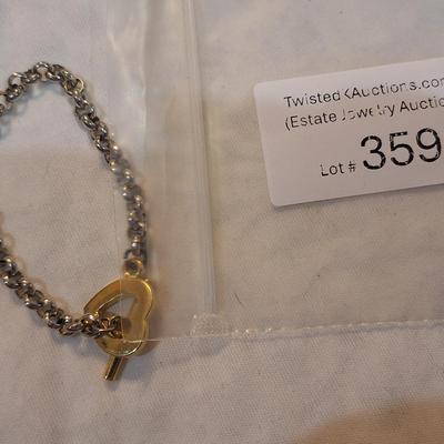 Sale Photo Thumbnail #1575: Multi color shell bracelet and a silver and gold tone bracelet
