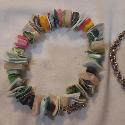 Sale Photo Thumbnail #1576: Multi color shell bracelet and a silver and gold tone bracelet