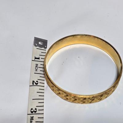 Thick gold toned necklace chain with several gold toned earrings and a bangle bracelet