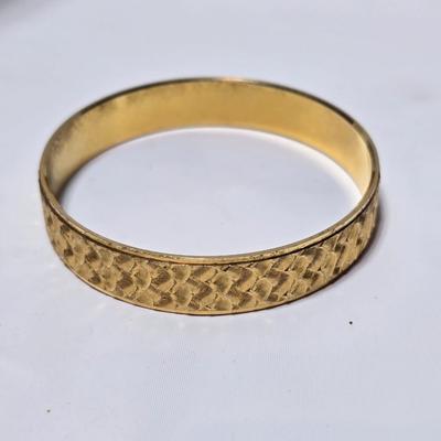 Thick gold toned necklace chain with several gold toned earrings and a bangle bracelet