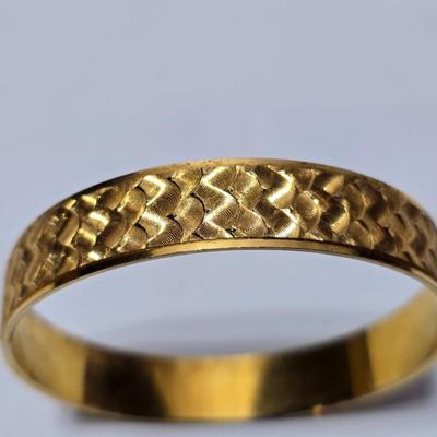 Thick gold toned necklace chain with several gold toned earrings and a bangle bracelet