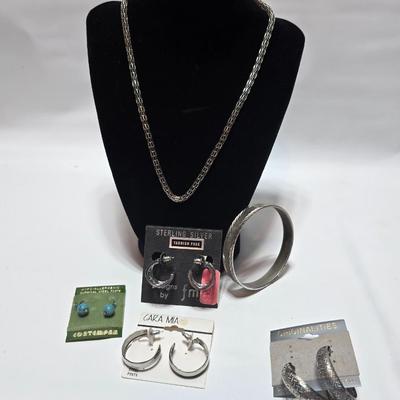 Silver tone Necklace Chain with several pairs of pierced earrings and silver tone bangle bracelet
