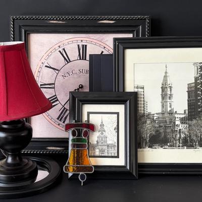 LOT 84: Home Decor Collection: Signed 1980 Photo of Philadelphia, Stained Glass Liberty Bell, Wall Clock, Lamp, Round Wall Mirror. 10x13...