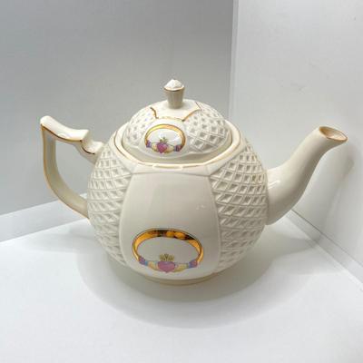 LOT 128: Donegal Ireland Parian China (Millennium 2000 Ad) Claddagh Teapot with Cream and Sugar Bowls