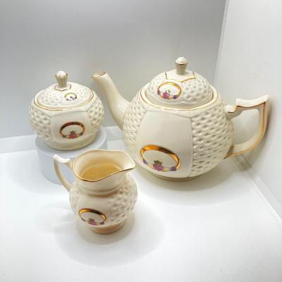 LOT 128: Donegal Ireland Parian China (Millennium 2000 Ad) Claddagh Teapot with Cream and Sugar Bowls