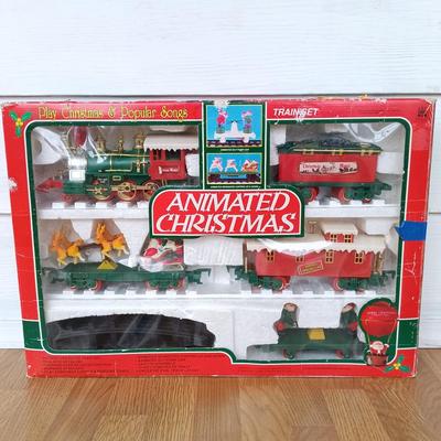 LOT 223: Vintage Christmas Train Sets with Santa in Rocking Chair & Rudolph and Santa