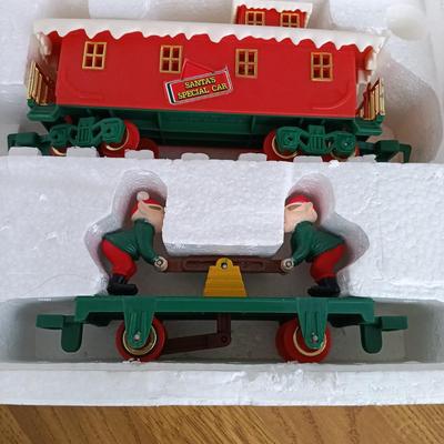 LOT 223: Vintage Christmas Train Sets with Santa in Rocking Chair & Rudolph and Santa