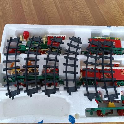 LOT 223: Vintage Christmas Train Sets with Santa in Rocking Chair & Rudolph and Santa