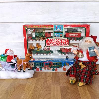 LOT 223: Vintage Christmas Train Sets with Santa in Rocking Chair & Rudolph and Santa