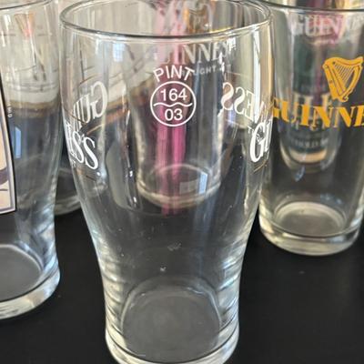 LOT 248: Guinness Collection: Wooden Clock, Pint Glasses and a Framed Poster