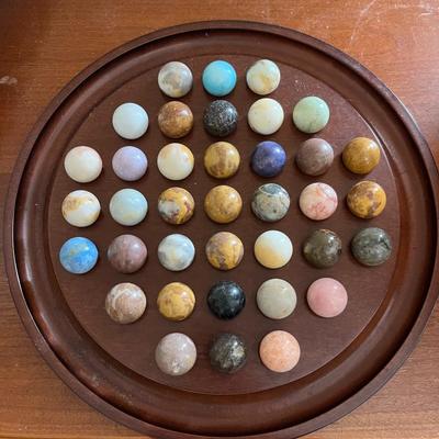 Sale Photo Thumbnail #146: Solo Noble Marble Solitaire..  the objective is to remove all but one marble, with the final marble ideally ending up in the center hole.  The board has 37 holes and is filled with various colored stone marbles.   Approximately 13.5" wide