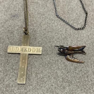 Chains with cross pendant and bird pin
