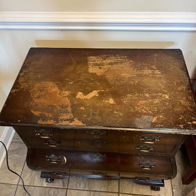 Sale Photo Thumbnail #172: Chippendale Style Bombe Chest of Drawers  Four Drawers.  Note Damage on the top of the chest.
Approximately 30"X18"X31"