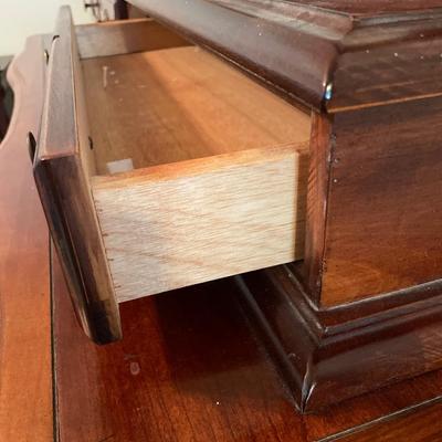 Tall wood dresser with mirror and shell design on doors