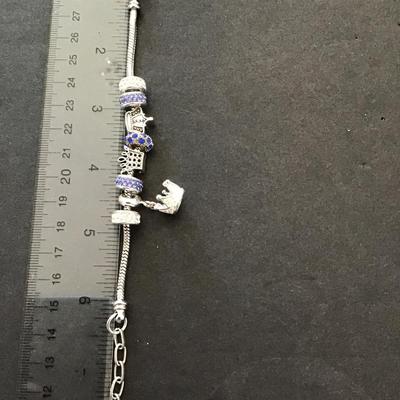 Sale Photo Thumbnail #97: Silvertone charm bracelet. Please see attached photos.