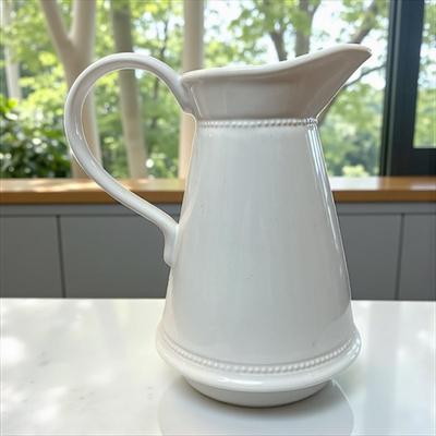 Sale Photo Thumbnail #337: White Glazed Pitcher With Large Hand and beaded bands around the neck and base   By Martha Stewart
Approximately 8" Tall