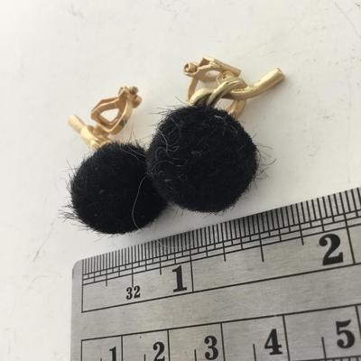 Gold tone black fuzzy clip on earrings