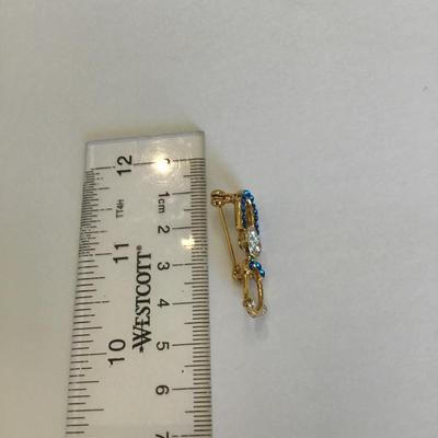 Gold tone brooch with Rhinestones