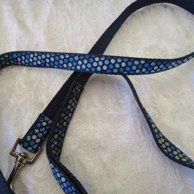 Sale Photo Thumbnail #151: 2 dog leashes, one new medium dog coat, 1 medium harness collar, Doggie cookie cutter with recipe cards. One leash is 5' x 3/4", one is 46" x 3/8"