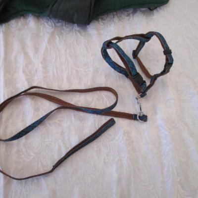 Sale Photo Thumbnail #149: 2 dog leashes, one new medium dog coat, 1 medium harness collar, Doggie cookie cutter with recipe cards. One leash is 5' x 3/4", one is 46" x 3/8"