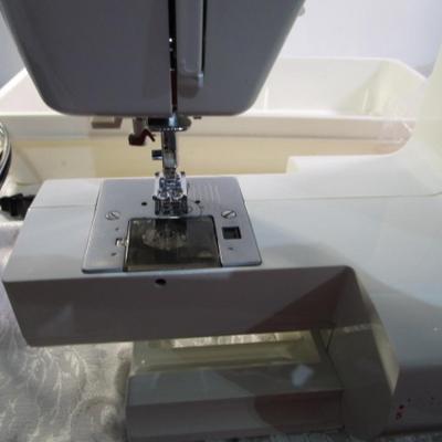 Sale Photo Thumbnail #409: Teacher's model, 27 built-in stiches, 1-step button holer, has free arm option, Like new condition, includes attachments, Model 6550
