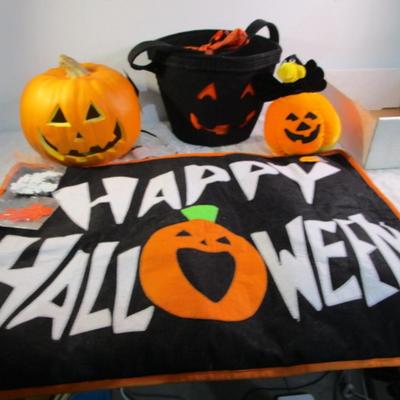 Sale Photo Thumbnail #430: Happy Halloween doormat,  new electric jack-o-lantern, Halloween basket & stuffed pumpkin, Doormat untested & takes 3 AG13 batteries not included, 2 bags Halloween confetti
