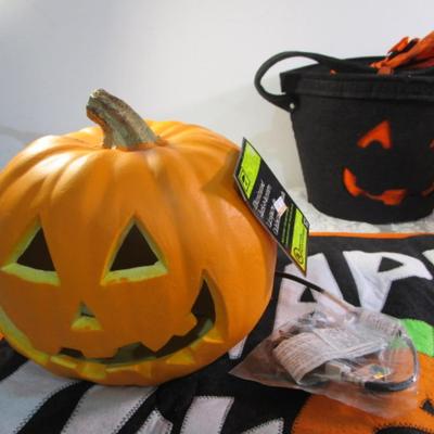 Sale Photo Thumbnail #432: Happy Halloween doormat,  new electric jack-o-lantern, Halloween basket & stuffed pumpkin, Doormat untested & takes 3 AG13 batteries not included, 2 bags Halloween confetti