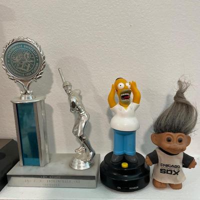 Vintage trophies with troll and Simpson figure
