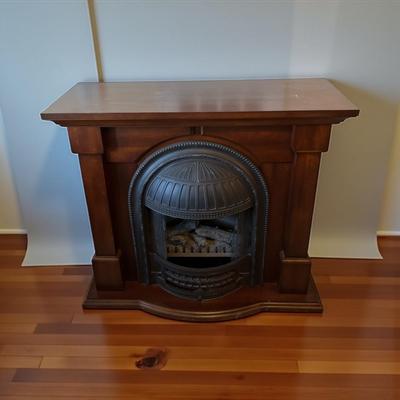 Sale Photo Thumbnail #667: Dimplex Electric Fireplace with Walnut Mantel Surround  Working and heats up.  Includes instructions and original Invoice
Approximately 47"X 17"X40"