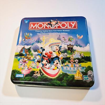 Sale Photo Thumbnail #1213: Disney Theme Park Monopoly Game in Metal Tin.  Missing Dice, Houses and Player pieces.