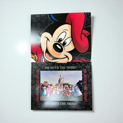 Sale Photo Thumbnail #1312: Walt Disney World Collectors Society Box including, The Magic Begins With Me Book, On With The Show Photo, Cast Holiday Celebration Framed Photo, I Year Anniversary Card, Two Disney Dollars, One December 31, 1999 Entrance Ticket, Disney Cash Handling Manu