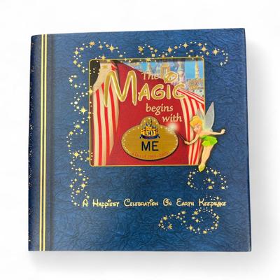 Sale Photo Thumbnail #1314: Walt Disney World Collectors Society Box including, The Magic Begins With Me Book, On With The Show Photo, Cast Holiday Celebration Framed Photo, I Year Anniversary Card, Two Disney Dollars, One December 31, 1999 Entrance Ticket, Disney Cash Handling Manu
