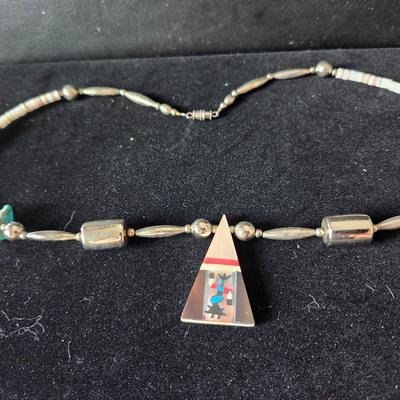 Sale Photo Thumbnail #170: The pendant is shell inlay with Mother of Pearl, turquoise, and sterling.  Zoom in to see the beautiful inlay work.  
The necklace is composed mostly of sterling beads.  Choker length.  Retail is $80 to $400.