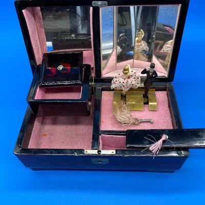Sale Photo Thumbnail #225: With key, music works.  Dancing Couple
Mirrored interior
Mother of Pearl inlay
Small chips on the front