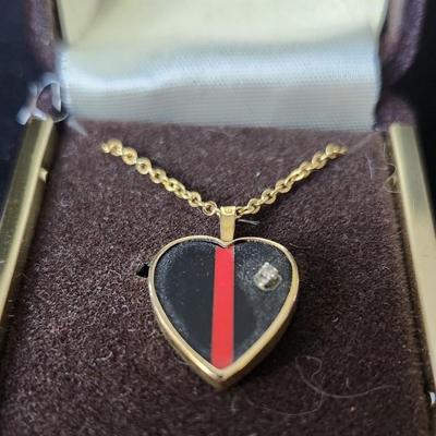 Sale Photo Thumbnail #294: Black and red stripe pendant set in gold tone setting, with genine diamond accent.
