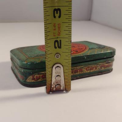 Sale Photo Thumbnail #178: Antique Lucky Strike Tobacco Tin- Circa 1920's- Approx 4 1/4" x 2 3/4" x 1 1/4" Tall.  Please see all pictures for condition.