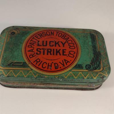 Sale Photo Thumbnail #172: Antique Lucky Strike Tobacco Tin- Circa 1920's- Approx 4 1/4" x 2 3/4" x 1 1/4" Tall.  Please see all pictures for condition.