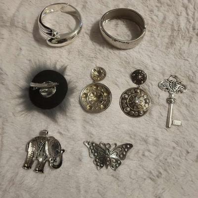2 Silver-tone bracelets 3 Pendants 1 Brooch/clip 1 Pair post earrings