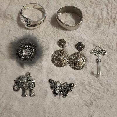 2 Silver-tone bracelets 3 Pendants 1 Brooch/clip 1 Pair post earrings