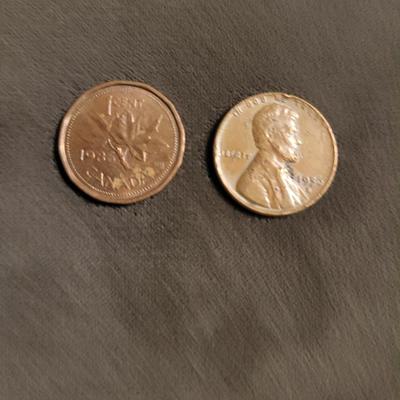Silver standing quarter can’t read date 1906 Indian head nickel 1956 D wheat penny 1986 Canadian penny