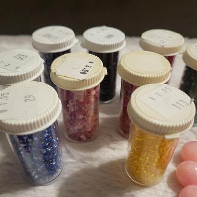 Nine bottles of beads natural rose beads, natural ruby beads